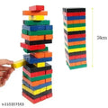 Colorful wooden block stacking game set with a hand pulling a yellow block from a tall tower, plus a side view showing the tower height marked 24cm on a white background.
