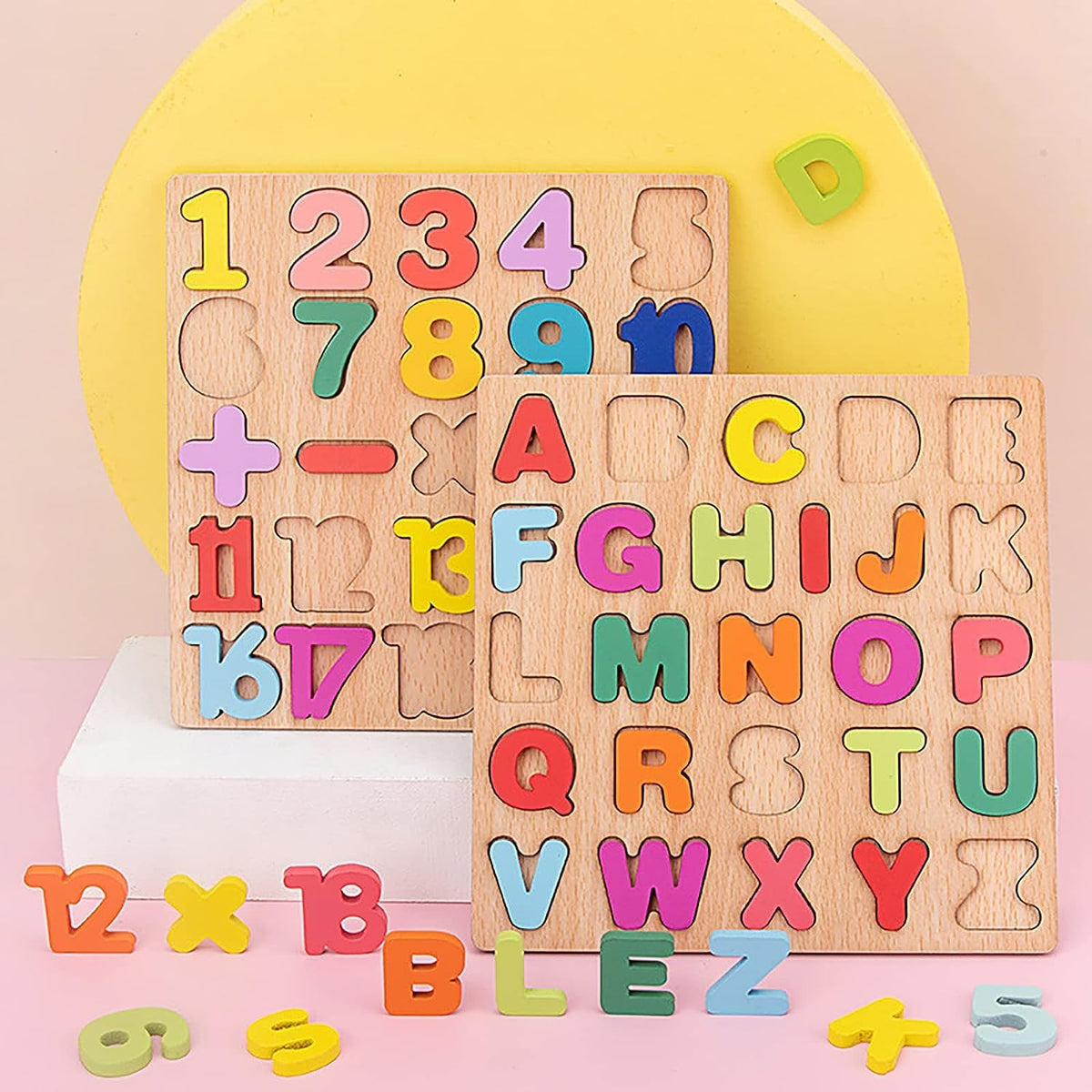 Wooden puzzle with colorful letters and numbers on a pink background
